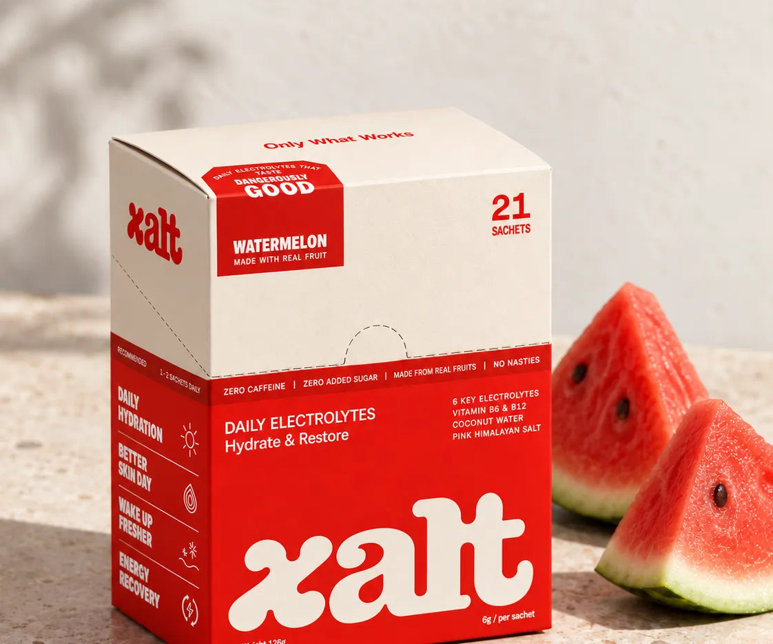A box of XALT Watermelon beside cut watermelon