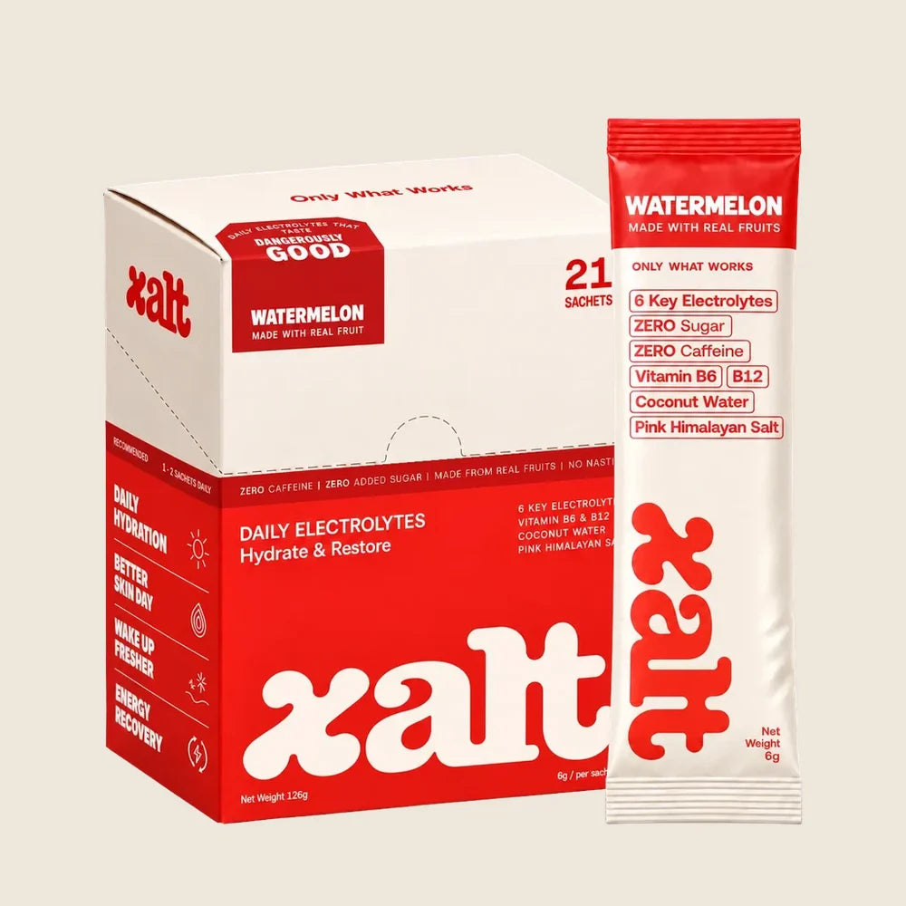 A box of XALT Watermelon beside cut watermelon